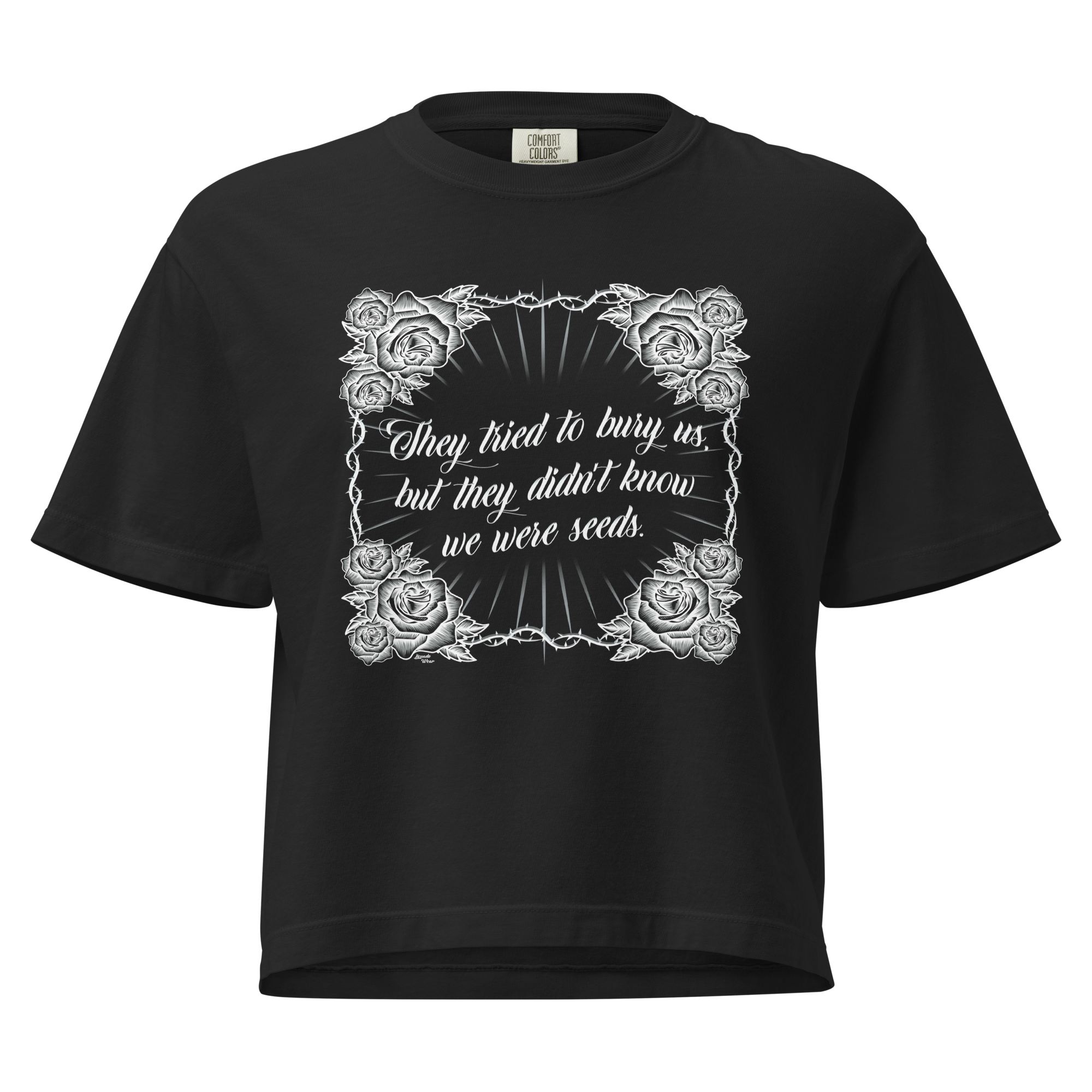 A woman wearing a t-shirt with the slogan 'They tried to bury us but they didn't know we were seeds'